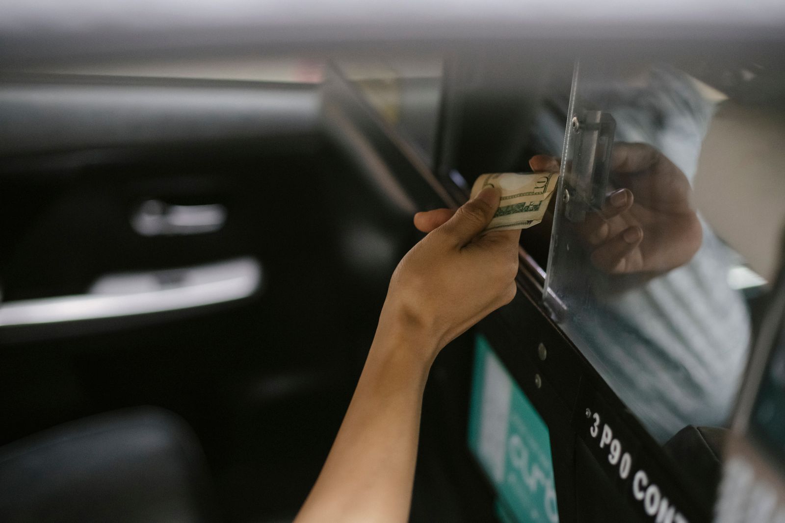 Passenger paying a taxi driver